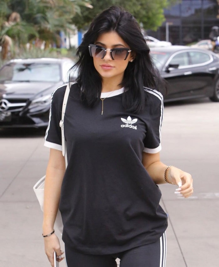 Kylie Jenner rocking a full Adidas outfit with a Miu Miu shades.